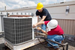  air-conditioning-service-technicians-working-on-a-unit